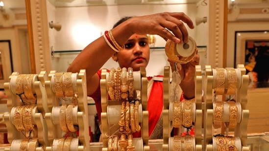 A saleswoman shows gold bangles to a customer at a jewellery showroom in Kolkata, India. (REUTERS/ File)