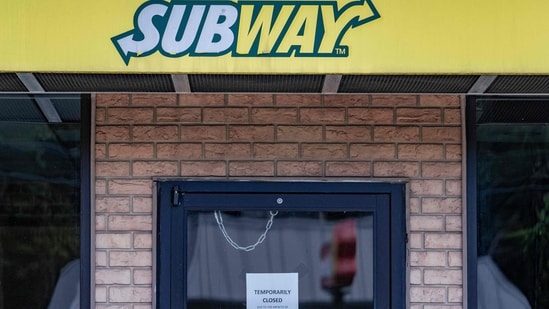 A temporarily closed sign hangs on the door of a Subway outlet.(AFP)