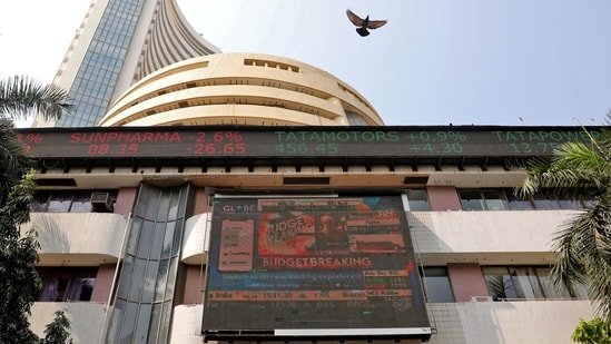 A bird flies past a screen displaying the Sensex results on the facade of the Bombay Stock Exchange (BSE) building in Mumbai.(REUTERS)