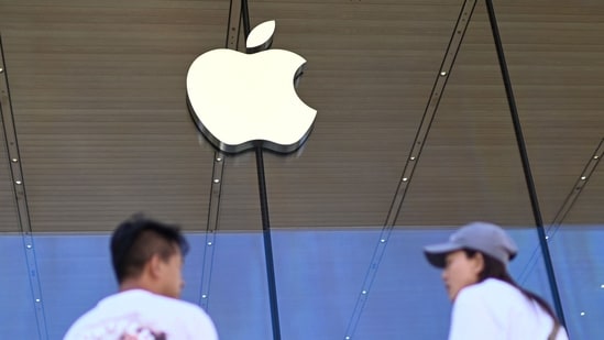 People stand outside an Apple store(AFP)