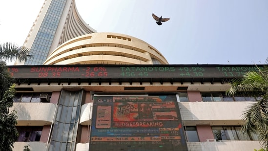 A bird flies past a screen displaying the Sensex results on the facade of the Bombay Stock Exchange (BSE) building in Mumbai.(REUTERS)