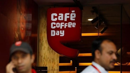 Men stand outside a Cafe Coffee Day outlet in New Delhi, India.(Reuters file)