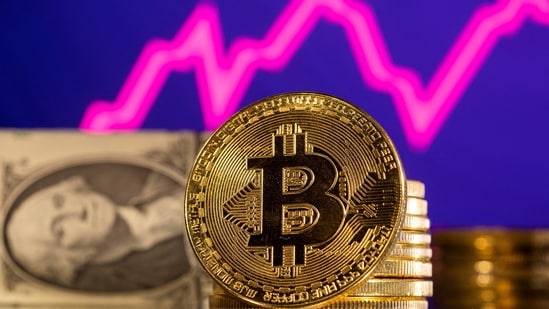 A representation of cryptocurrency bitcoin is seen in front of a stock graph and U.S. dollar in this illustration.(REUTERS)