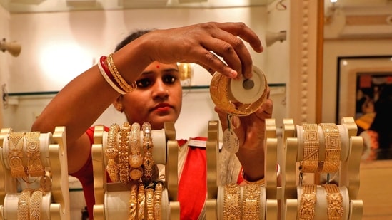 A saleswoman shows gold bangles to a customer at a jewellery showroom in Kolkata, India. (REUTERS/ File)