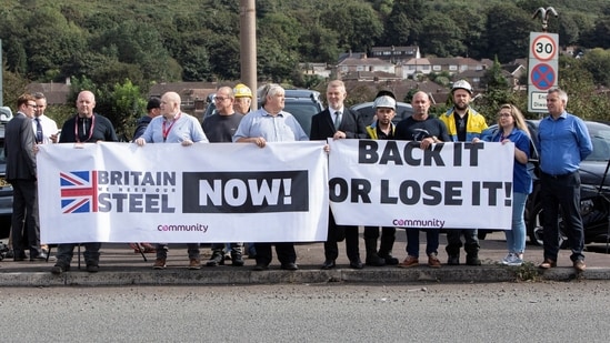 Protesters hold signs outside Tata Steel, on the day of a government announcement about steel industry investments, in Port Talbot, Britain September 15, 2023. REUTERS/Joann Randles(Reuters)