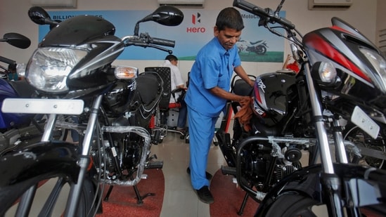 A worker cleans a bike inside a Hero MotoCorp showroom in Mumbai.(REUTERS)