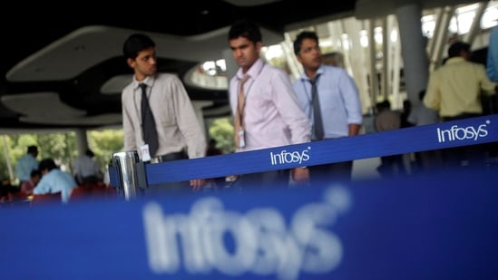 Employees of Indian software company Infosys walk past Infosys logos at their campus in the Electronic City area in Bengaluru September 4.(REUTERS)