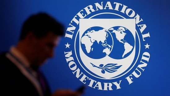 A man walks past the IMF banner.(REUTERS)