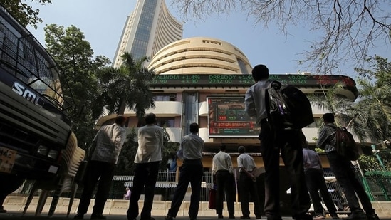 People look at a screen displaying the Sensex results on the facade of the Bombay Stock Exchange (BSE) building in Mumbai.(Reuters)