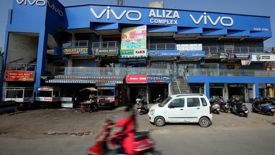 A scooterist rides past a shopping complex with the billboard of Chinese smartphone maker Vivo in Ahmedabad. (Reuters file photo)