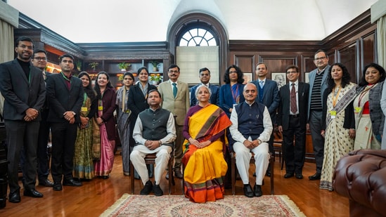 Union finance minister Nirmala Sitharaman with ministers of state Pankaj Chaudhary and Bhagwat Karad and her team of officials a day before the presentation of the Interim Budget 2024, at her North Block office in New Delhi(PTI)