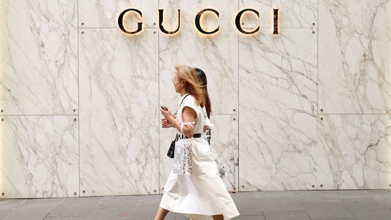 Pedestrians walk past a Gucci store in Sydney, Australia.(Bloomberg)