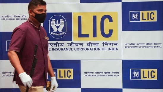 A man walks past a hoarding of Life Insurance Corporation of India (LIC) in Mumbai.(REUTERS file)