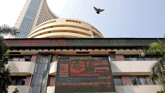 A bird flies past a screen displaying the Sensex results on the facade of the Bombay Stock Exchange (BSE) building in Mumbai.(Reuters)