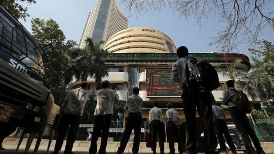 People look at a screen displaying the Sensex results on the facade of the Bombay Stock Exchange (BSE) building in Mumbai.(REUTERS)