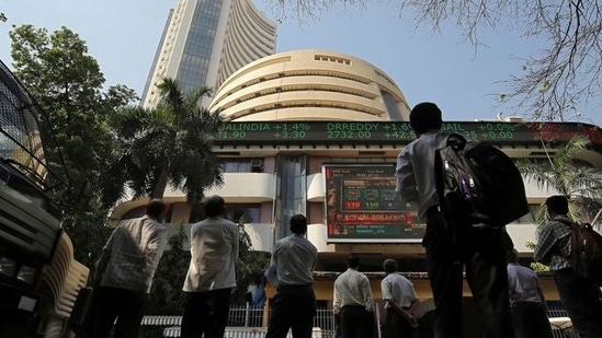 Sensex Today: People look at a screen displaying the Sensex results on the facade of the Bombay Stock Exchange (BSE) building in Mumbai.(Reuters)