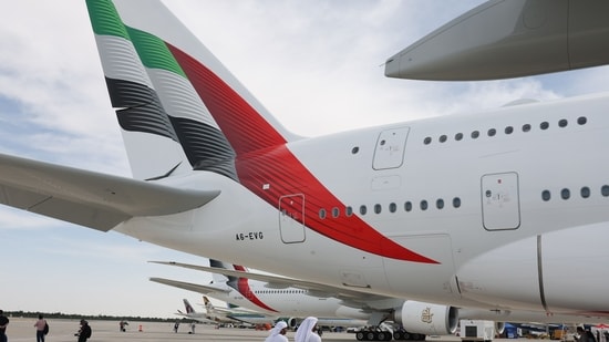 Emirates pre-approved visas for Indians: Attendees walk under the tail of an Airbus A380-800 passenger aircraft, operated by Emirates Airlines, at the Dubai Air Show in Dubai.(Bloomberg)