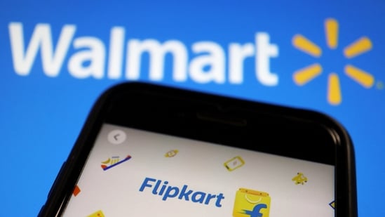 A mobile phone showing an image of Indian online retailer Flipkart is seen in front of a Walmart Inc logo displayed.(Reuters)