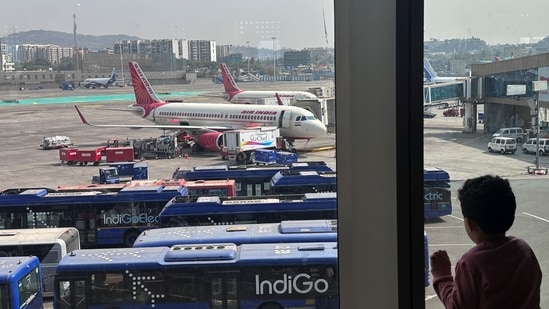 A boy looks at Air India airline passenger aircrafts parked at the Chhatrapati Shivaji Maharaj International Airport in Mumbai.(Reuters)