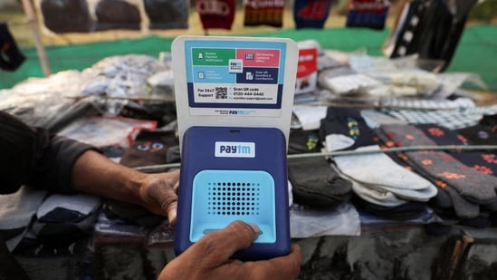 Paytm crisis: Cutlery vendor switches on Paytm, a digital payments firm, speaker to receive received payment details at a roadside market in Ahmedabad.(REUTERS/Amit Dave)