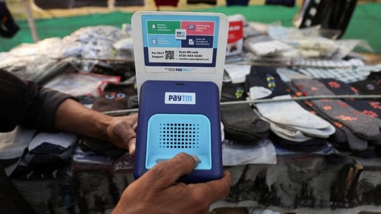 Paytm Crisis: Cutlery vendor switches on Paytm, a digital payments firm, speaker to receive received payment details at a roadside market in Ahmedabad.(Reuters)