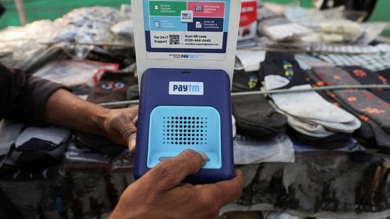 Paytm crisis: Cutlery vendor switches on Paytm, a digital payments firm, speaker to receive received payment details at a roadside market in Ahmedabad.(Reuters)