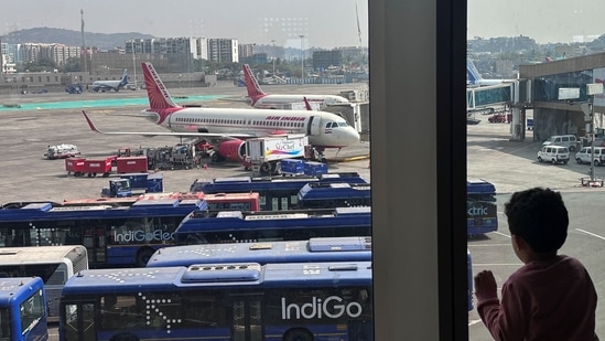 A boy looks at Air India airline passenger aircrafts parked at the Chhatrapati Shivaji Maharaj International Airport in Mumbai, India.(Reuters)