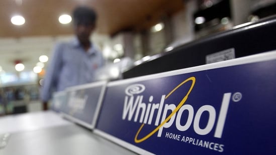 An employee stands next to a Whirlpool washing machine inside a home appliances showroom in New Delhi August 27, 2013. REUTERS/Anindito Mukherjee (INDIA - Tags: BUSINESS)/File Photo